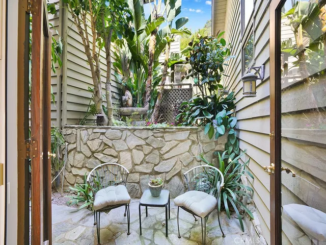 a view of a dining room with furniture large windows and wooden floor