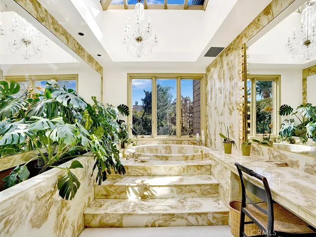 a front view of a house with a yard and fountain