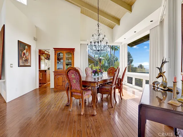 a kitchen with stainless steel appliances granite countertop a stove a sink dishwasher and cabinets with wooden floor