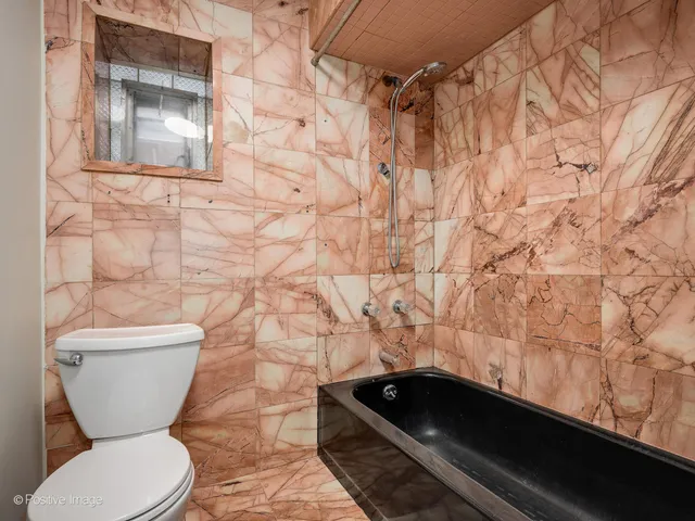 a bathroom with a toilet and a shower curtain