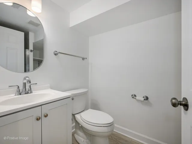 a bathroom with a sink a toilet and mirror