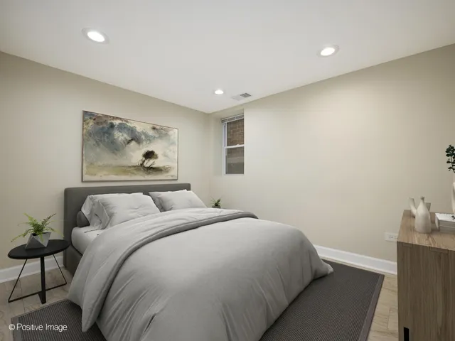 a bedroom with a bed and painting on the wall