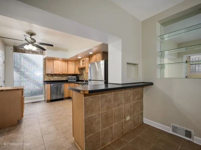 a kitchen with stainless steel appliances a sink a stove top oven a counter space and cabinets