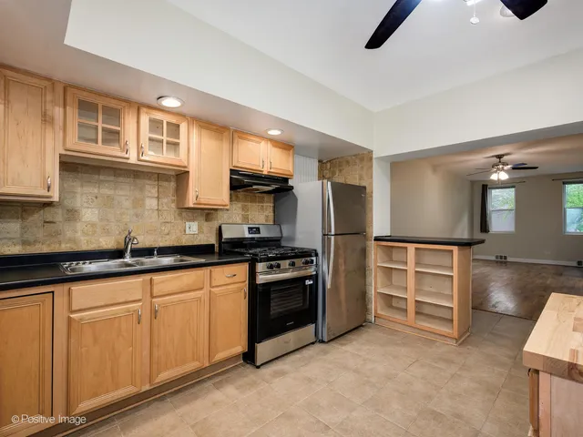 a kitchen with cabinets and stainless steel appliances