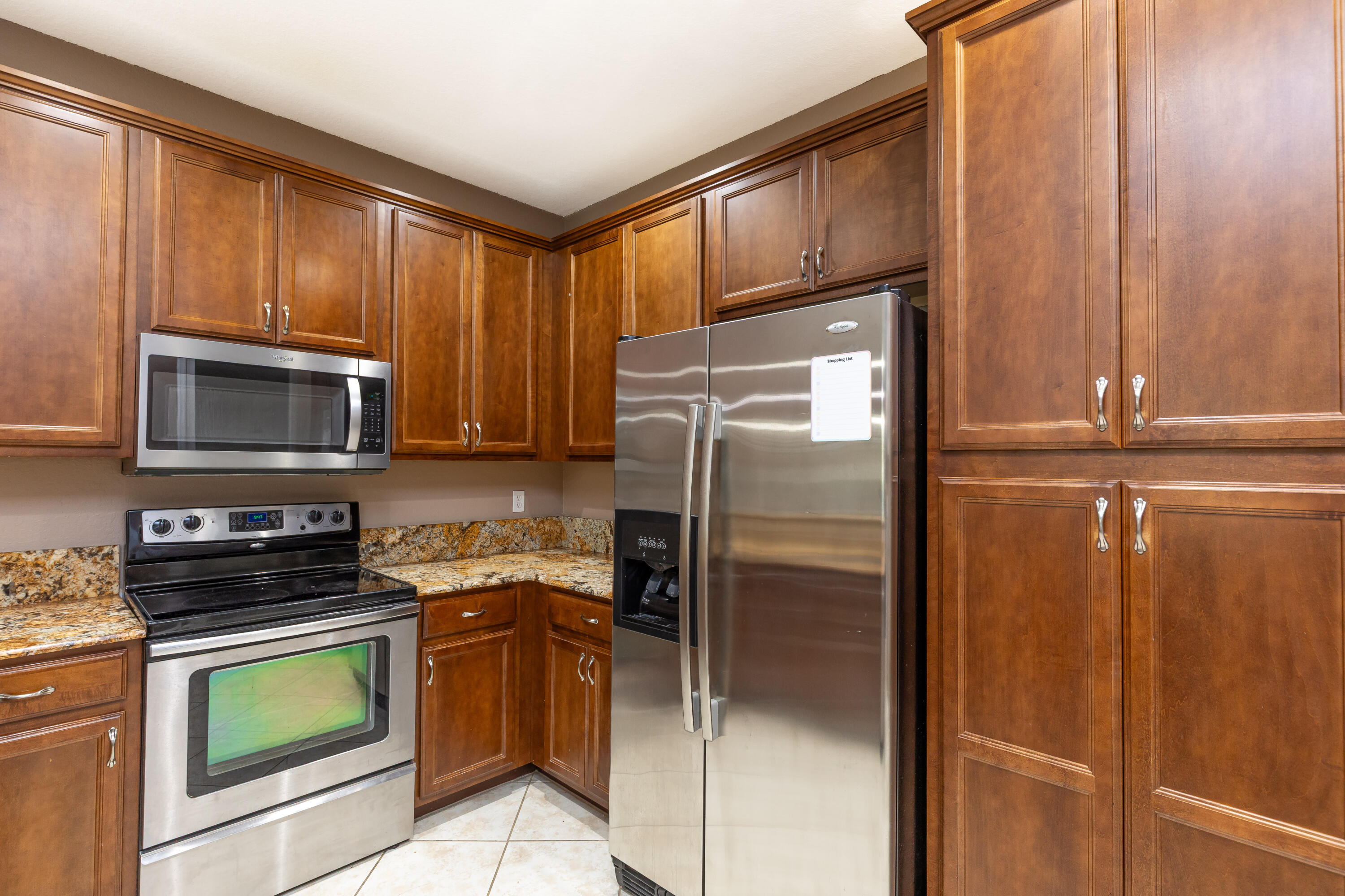 7782 Paddock Place Davie, FL 33328 - Photo 13 of 40 a kitchen with a refrigerator stove and microwave