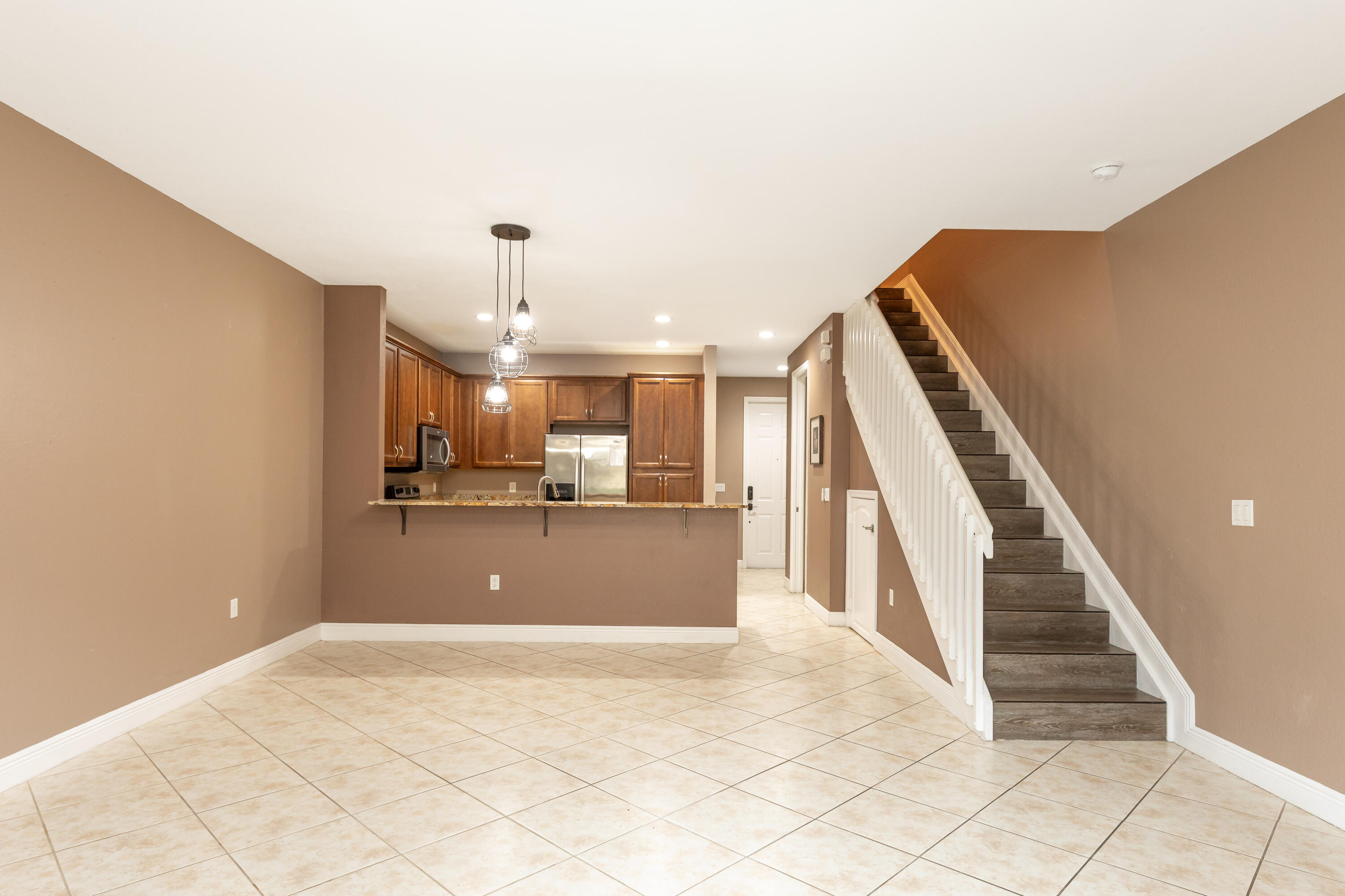 7782 Paddock Place Davie, FL 33328 - Photo 19 of 40 a view of a livingroom with wooden floor and stairs