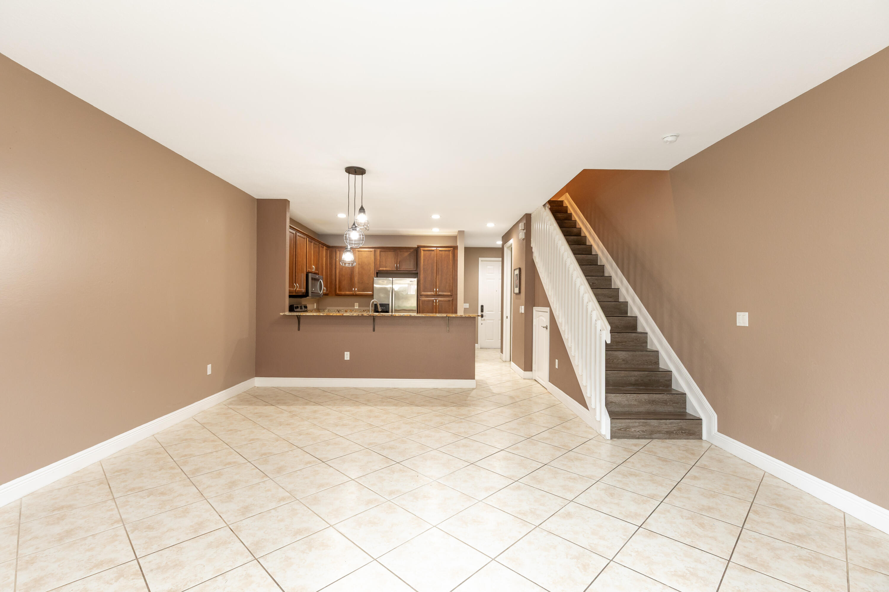 7782 Paddock Place Davie, FL 33328 - Photo 20 of 40 a view of a kitchen with furniture and stairs