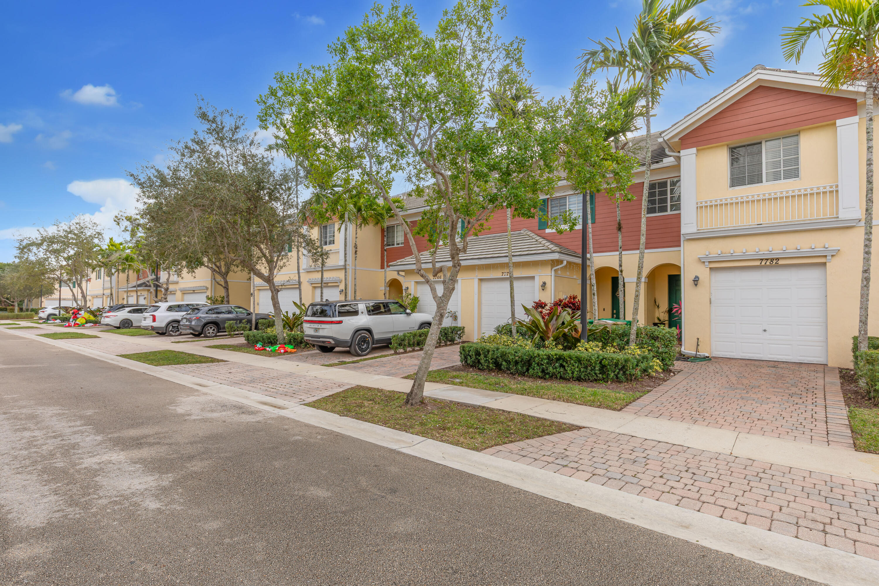 7782 Paddock Place Davie, FL 33328 - Photo 2 of 40 a view of a white house with a large tree and plants