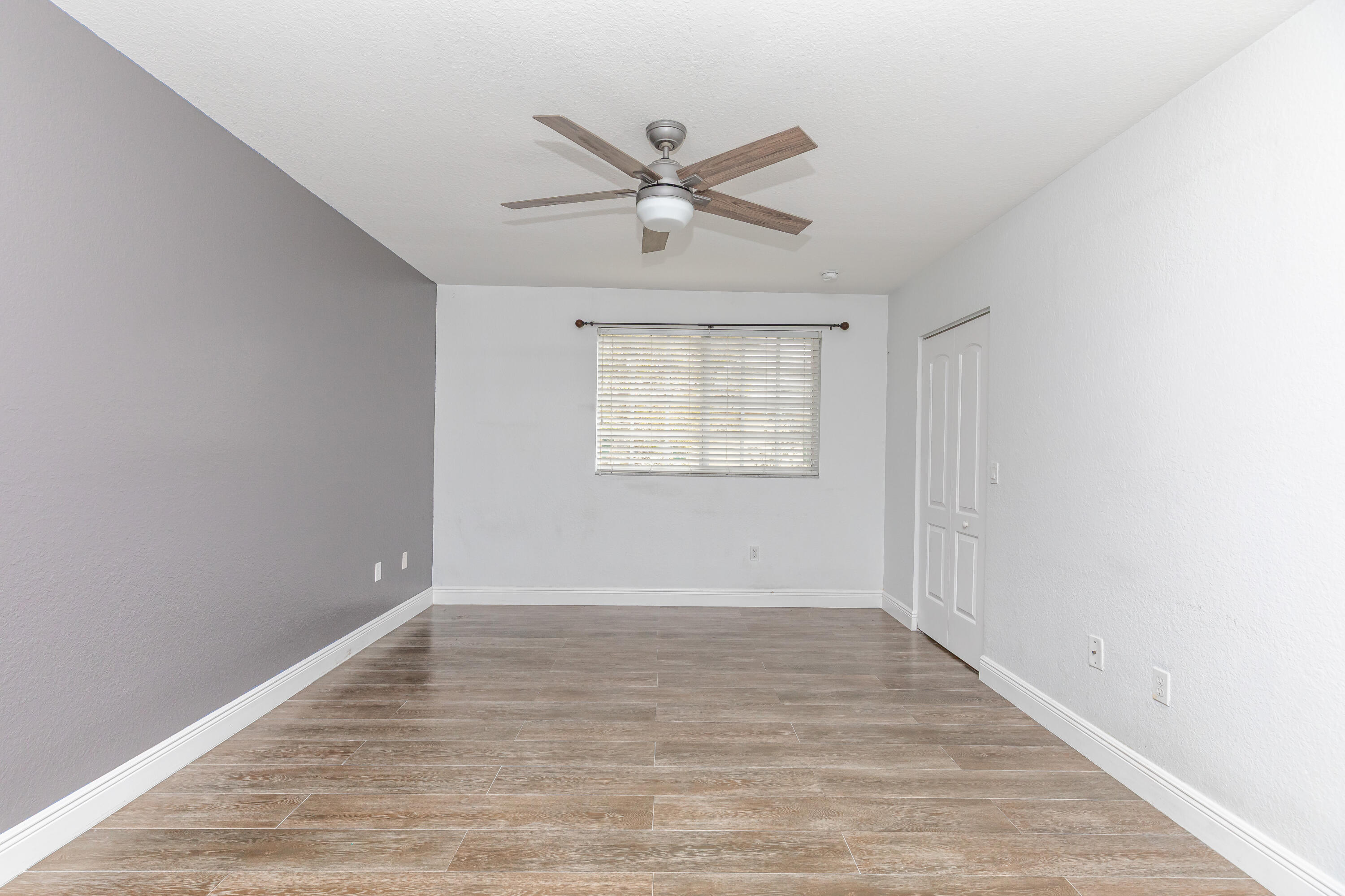 7782 Paddock Place Davie, FL 33328 - Photo 23 of 40 wooden floor in an empty room with a window