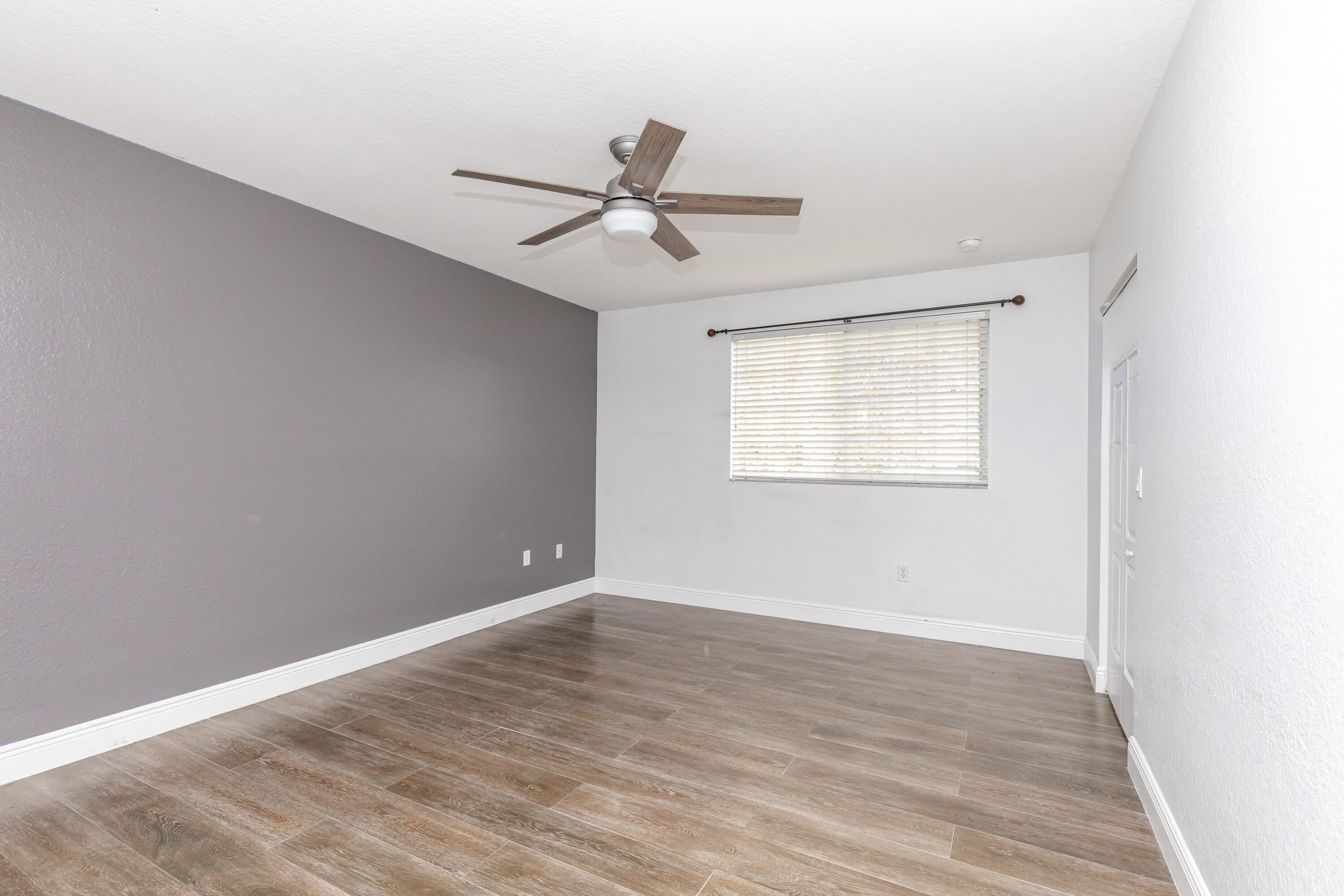 7782 Paddock Place Davie, FL 33328 - Photo 25 of 40 an empty room with wooden floor fan and windows