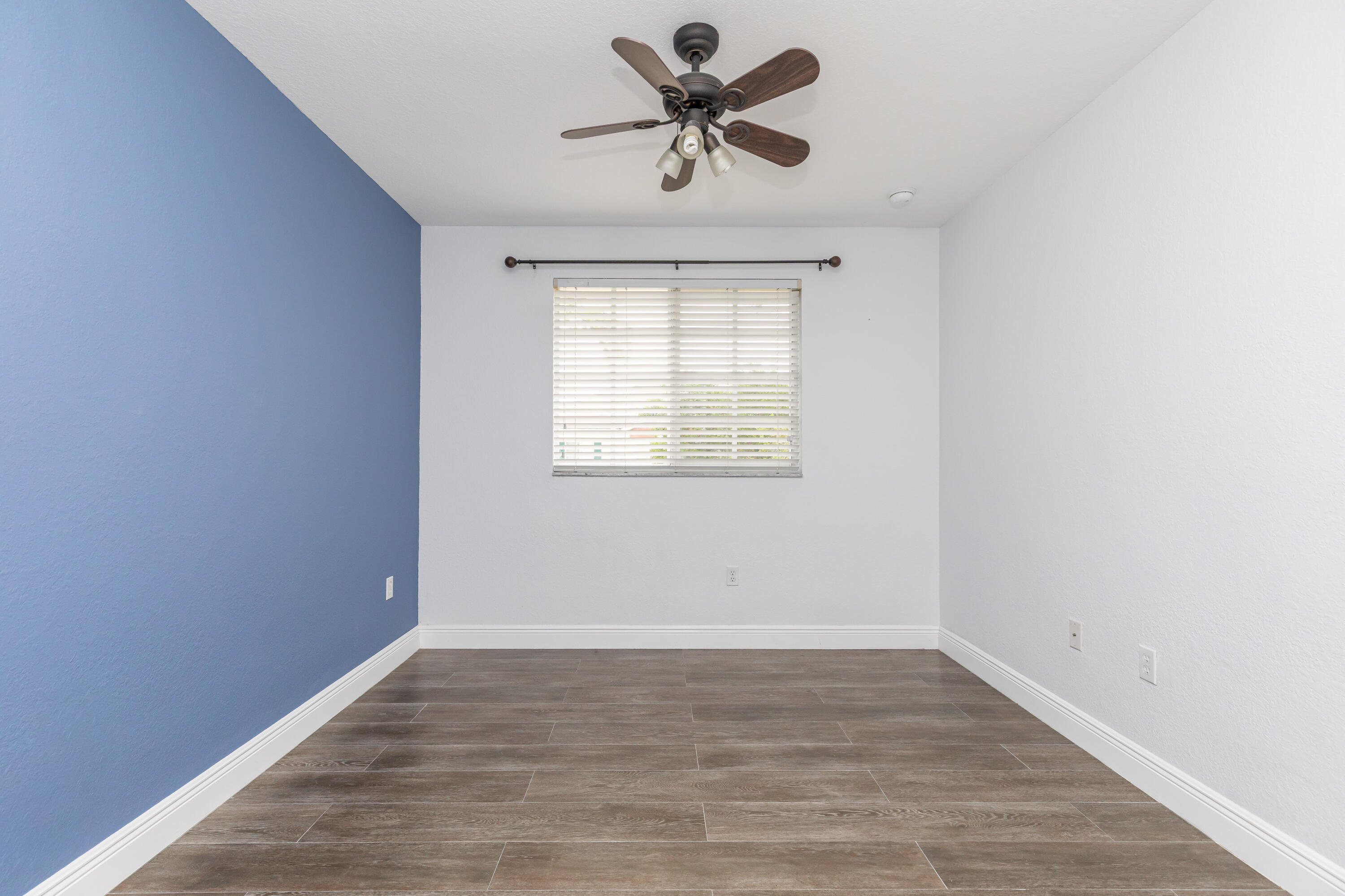 7782 Paddock Place Davie, FL 33328 - Photo 29 of 40 wooden floor in an empty room with a window