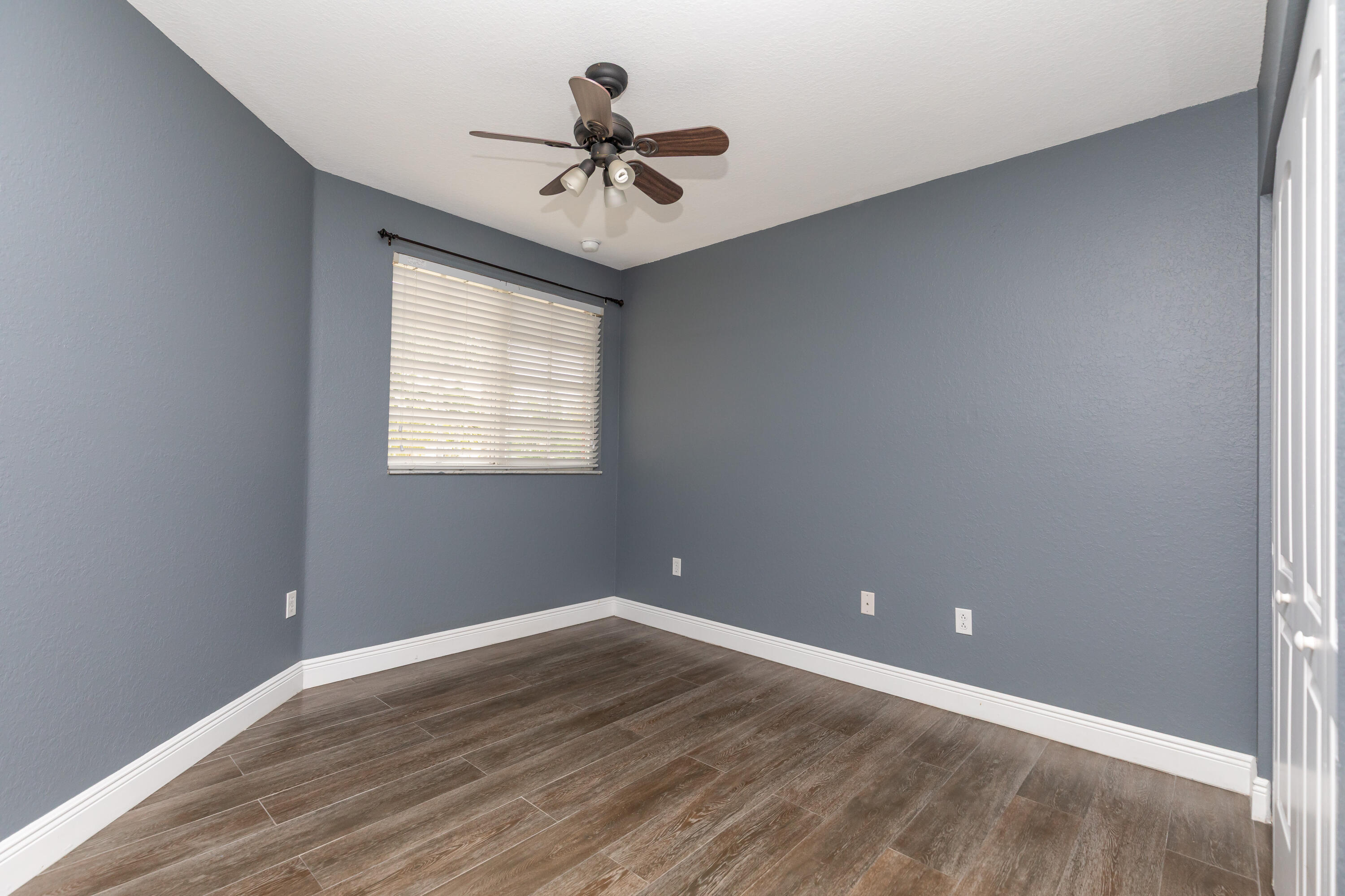 7782 Paddock Place Davie, FL 33328 - Photo 31 of 40 a view of a big room with wooden floor and windows