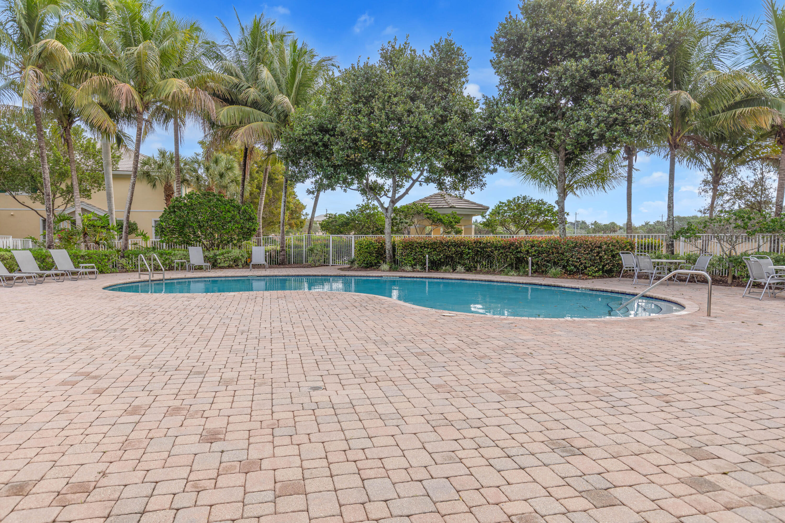 7782 Paddock Place Davie, FL 33328 - Photo 39 of 40 a view of a swimming pool and trees in the background