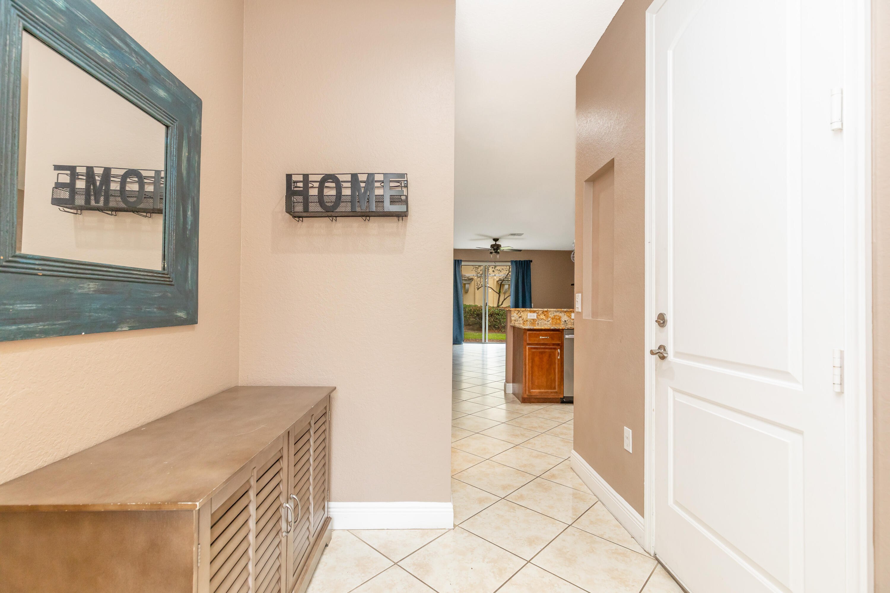 7782 Paddock Place Davie, FL 33328 - Photo 4 of 40 a kitchen with a refrigerator and a stove top oven