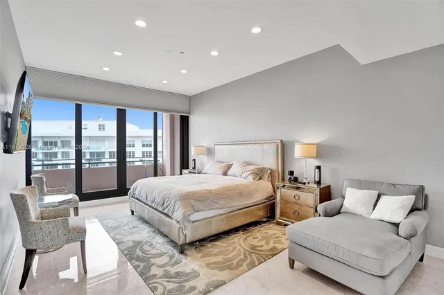 a spacious bedroom with a large bed and a large window