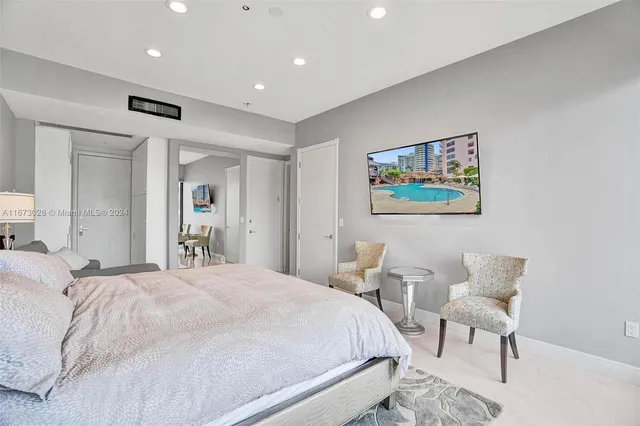 a bedroom with a bed and a chair