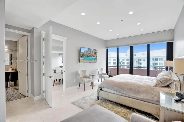 a bedroom with a large bed and a large window