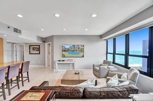 a living room with furniture and a floor to ceiling window