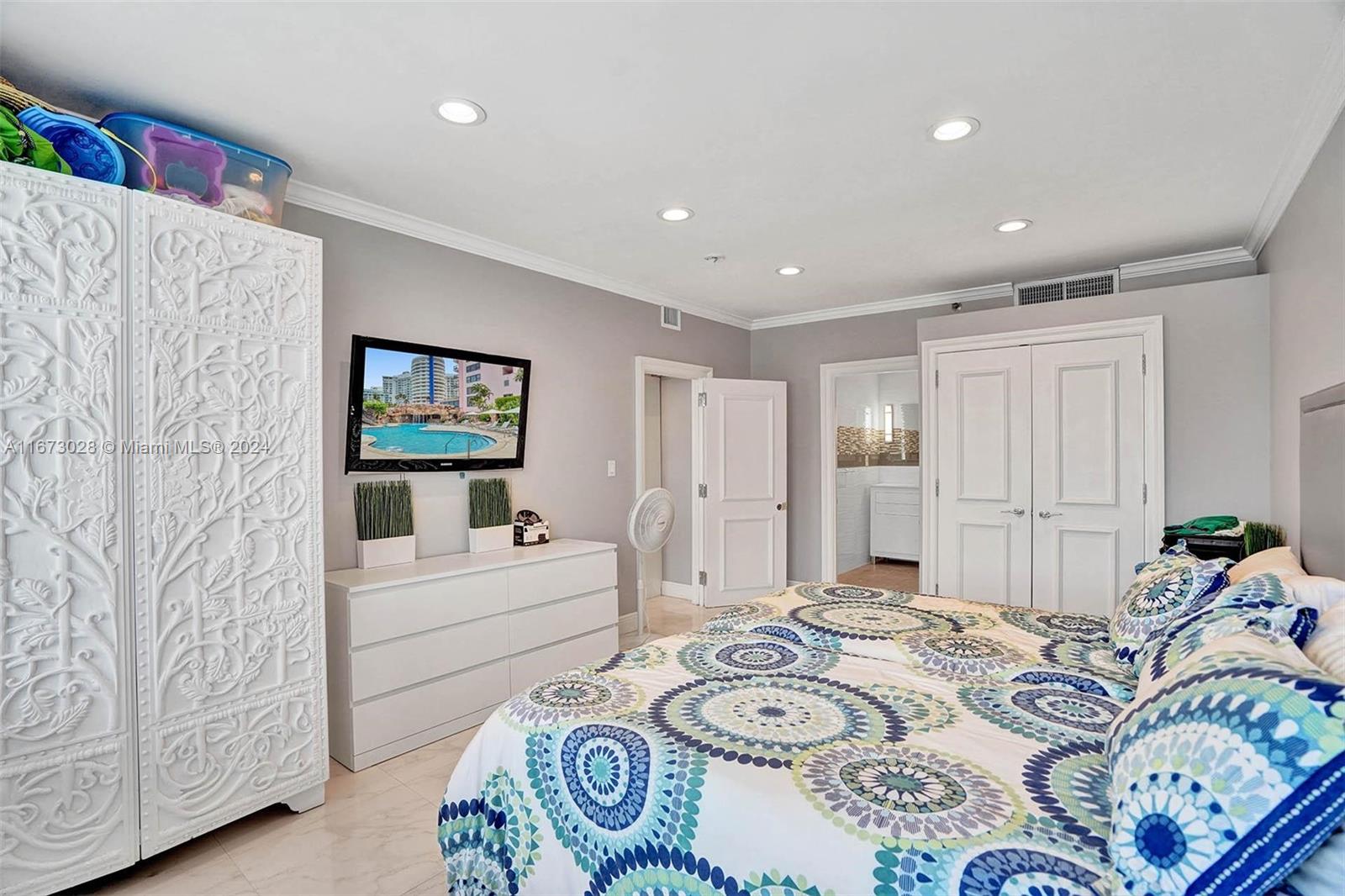 5225 Collins Avenue, Unit PH7 Miami Beach, FL 33140 - Photo 23 of 50 a bedroom with furniture and a wooden floor