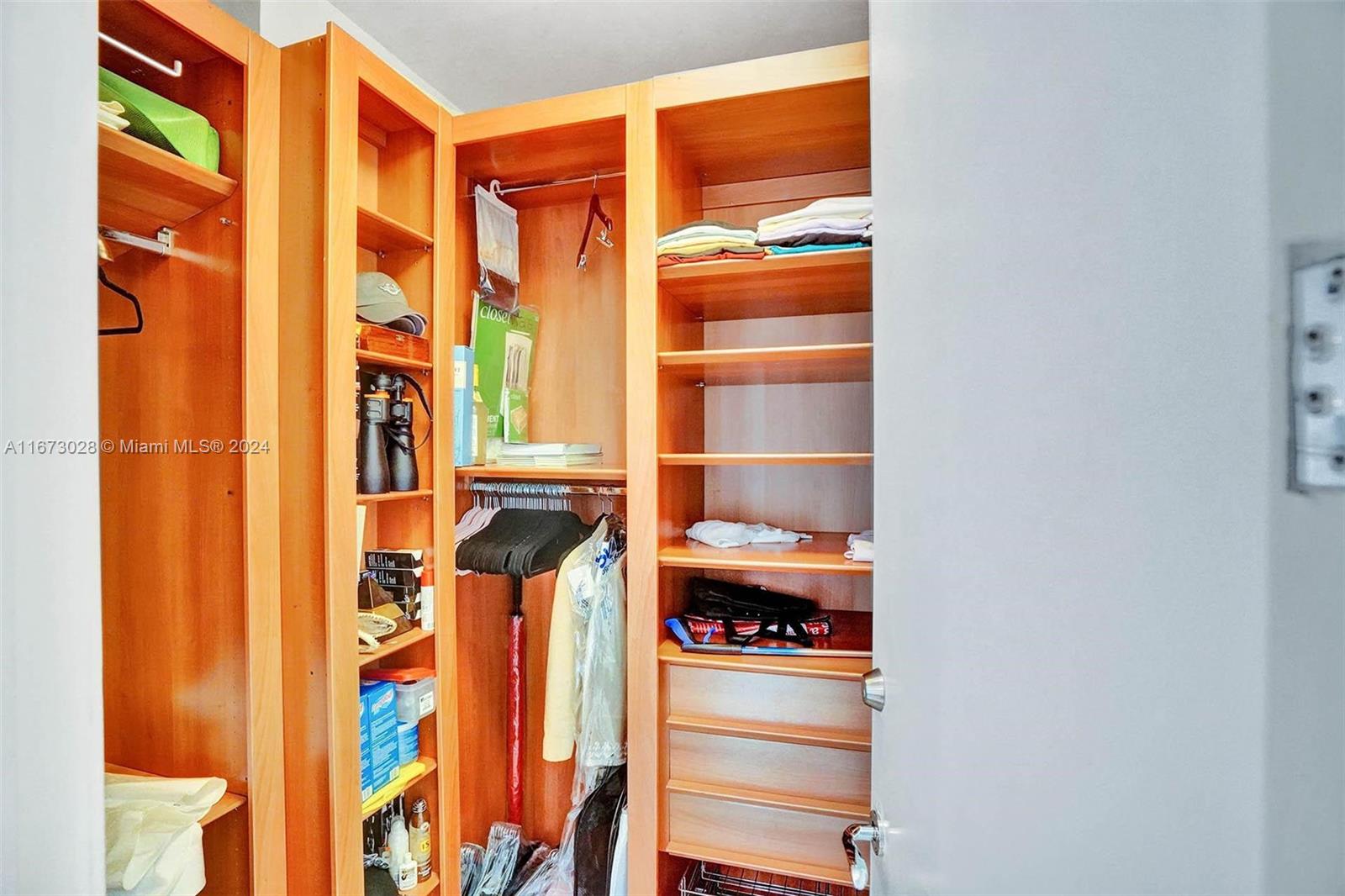 5225 Collins Avenue, Unit PH7 Miami Beach, FL 33140 - Photo 35 of 50 a view of walk in closet with clothes and shoes