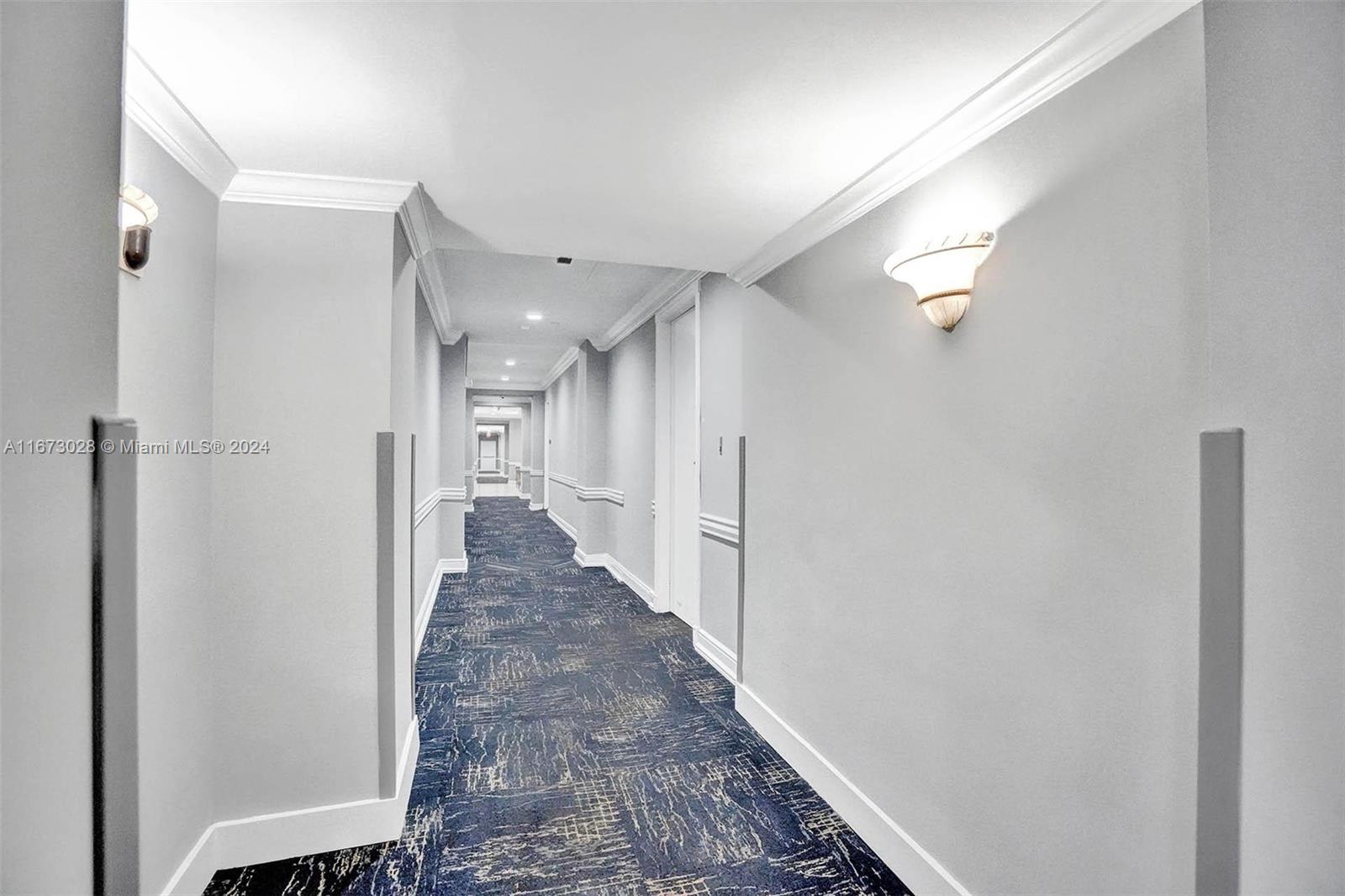 5225 Collins Avenue, Unit PH7 Miami Beach, FL 33140 - Photo 37 of 50 a view of a hallway with a wooden floor