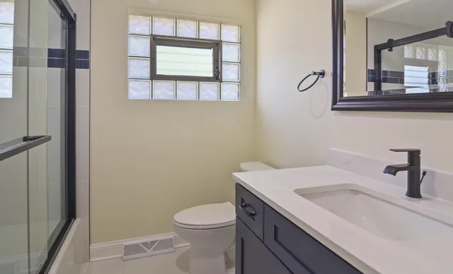 a bathroom with a shower and a sink