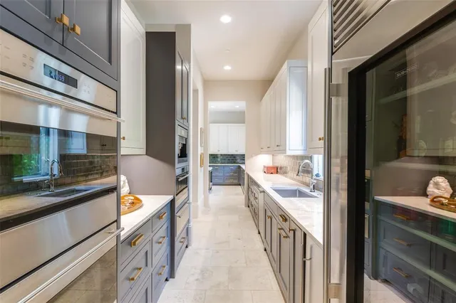 a view of a kitchen with a sink and cabinets