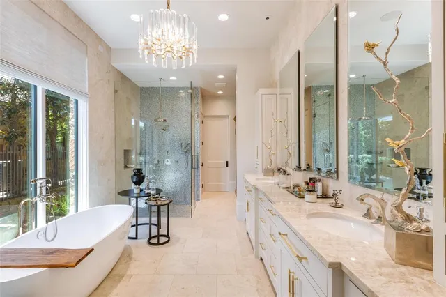 a large spacious bathroom with a tub sink shower and mirror