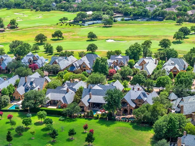 a view of a city with lots of residential buildings ocean and mountain view in back