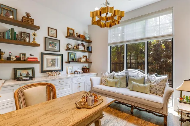 a living room with fireplace furniture and a large window