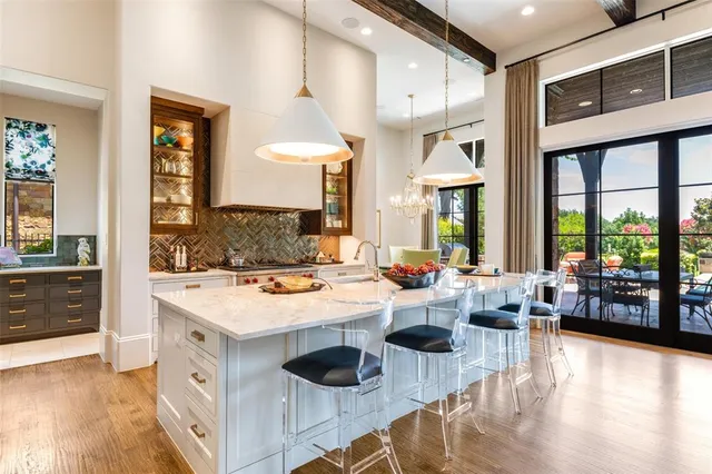 a large kitchen with a large window and stainless steel appliances