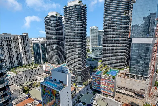 a view of balcony with a couple of cars parked on road