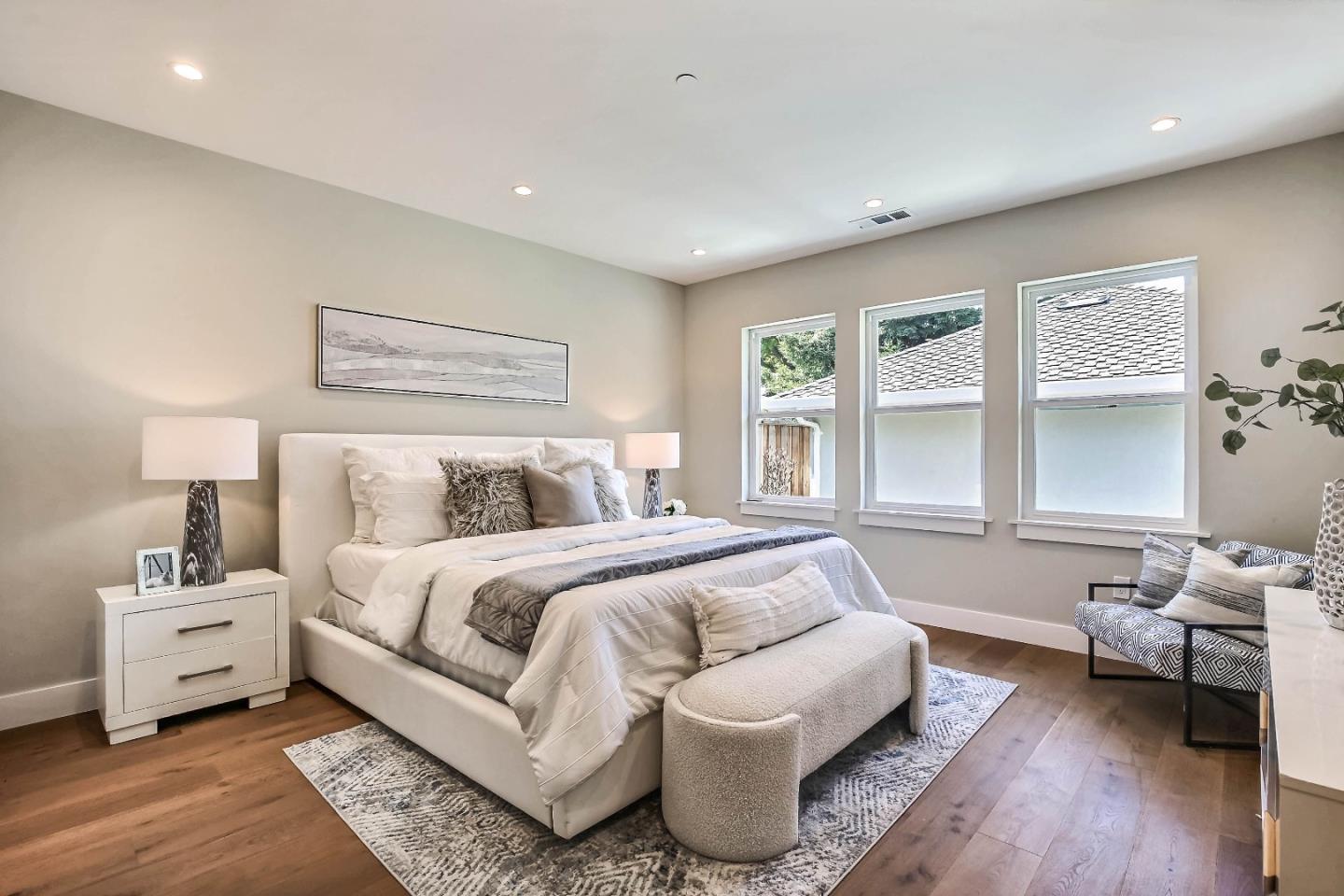 267 Willow Road Menlo Park, CA 94025 - Photo 17 of 24 a spacious bedroom with a bed and wooden floor