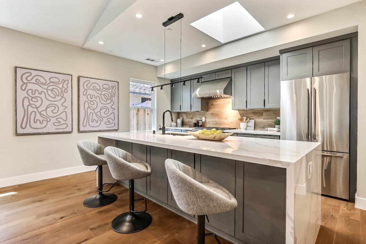 267 Willow Road Menlo Park, CA 94025 - Photo 6 of 24 a kitchen with stainless steel appliances granite countertop a sink a stove a refrigerator and island with wooden floor