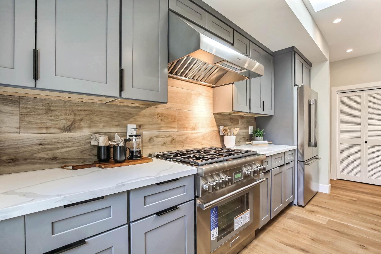 267 Willow Road Menlo Park, CA 94025 - Photo 9 of 24 a kitchen with granite countertop a stove and a white cabinets