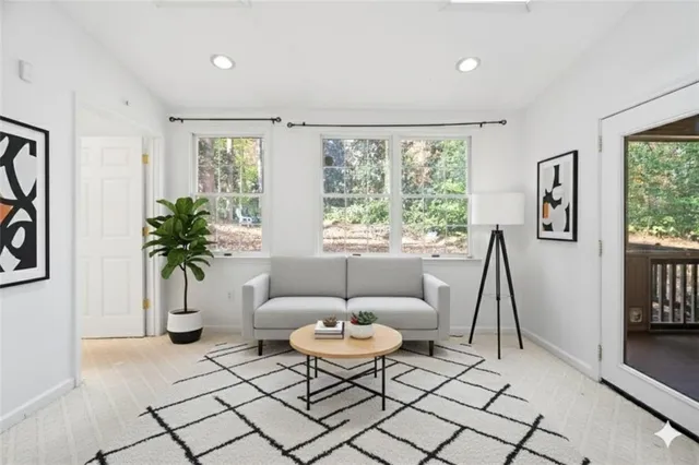 a living room with furniture and a large window
