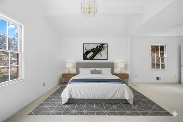 a bedroom with a bed and window