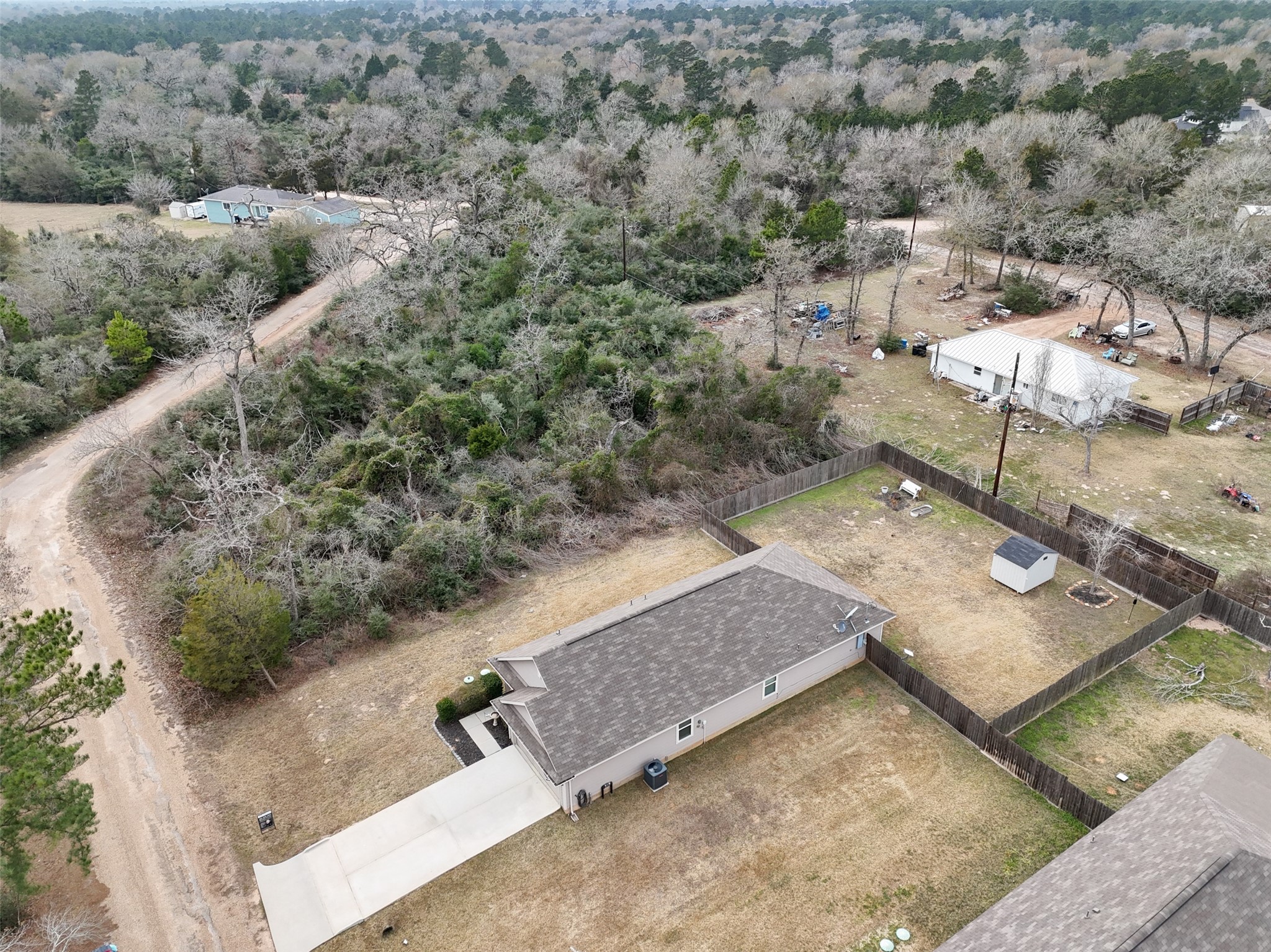 26431 Pin Oak Drive Hempstead, TX 77445 - Photo 27 of 32 Aerial angle showcasing the backyard space and wooded buffer along the property line.