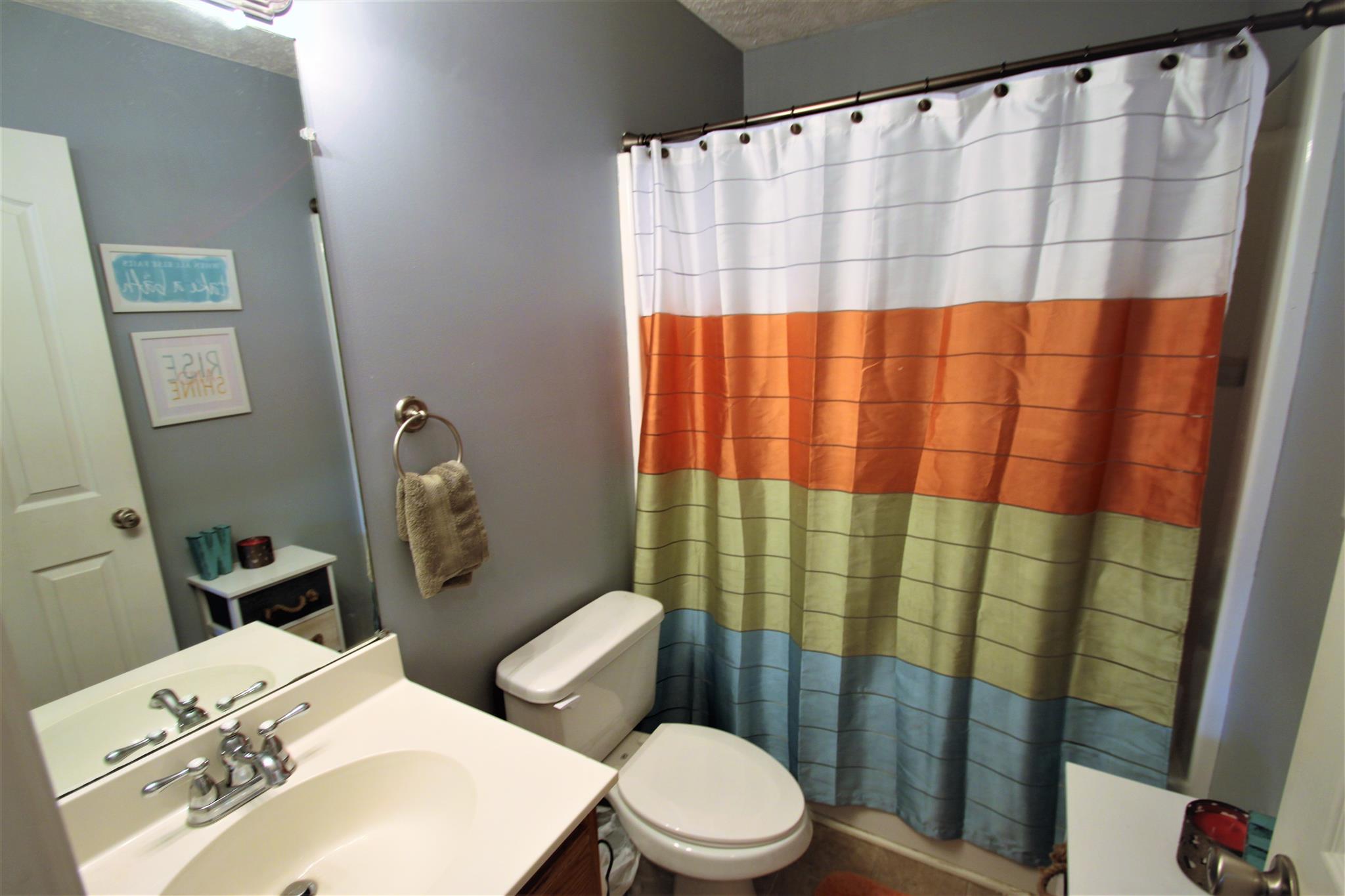 37 Ferrells Loop Road Manchester, TN 37355 - Photo 12 of 18 a bathroom with a sink a toilet and shower curtain