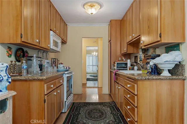 a kitchen with stainless steel appliances granite countertop a stove and cabinets