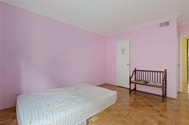 a bedroom with a bed and a chair