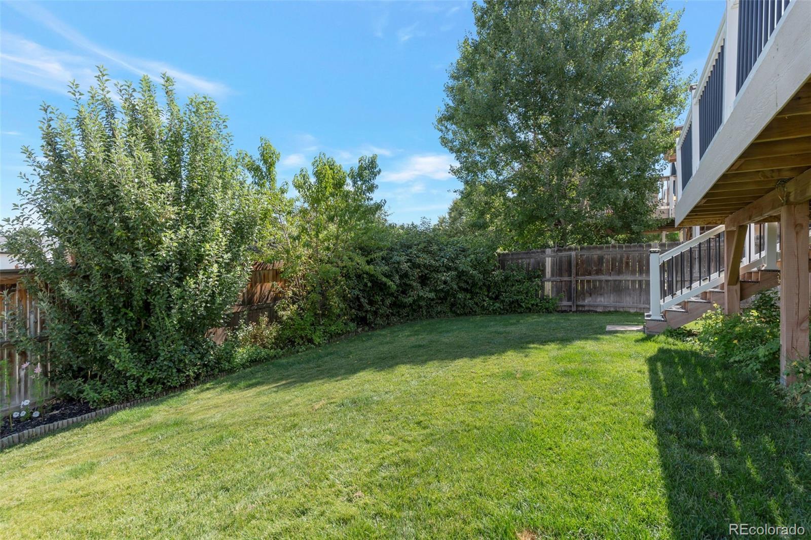 6794 West 98th Circle Westminster, CO 80021 - Photo 39 of 43 a backyard of a house with lots of green space