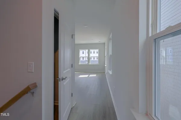 a kitchen with cabinets wooden floor and stainless steel appliances
