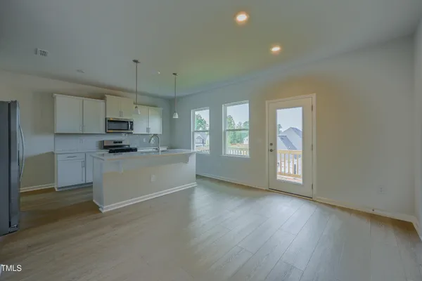a kitchen with sink a refrigerator and cabinets