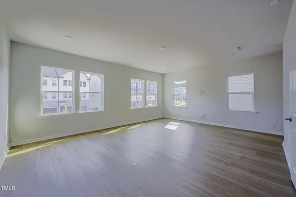 a view of entryway and gallery with wooden floor