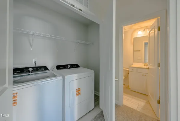 a bathroom with a toilet a sink a mirror a bathtub and vanity