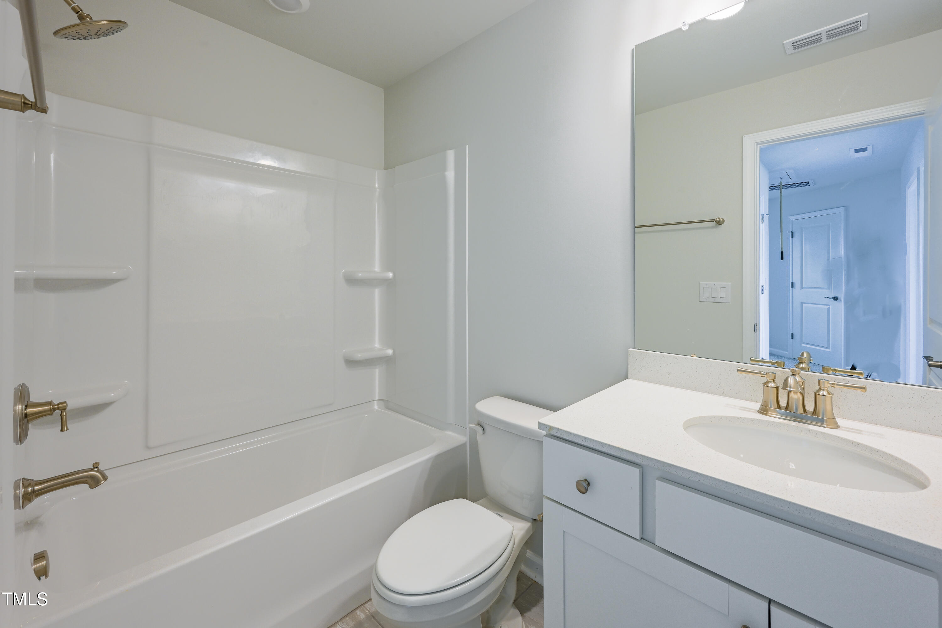 1511 Tamarisk Lane Durham, NC 27703 - Photo 26 of 26 a bathroom with a toilet a sink a mirror a bathtub and vanity