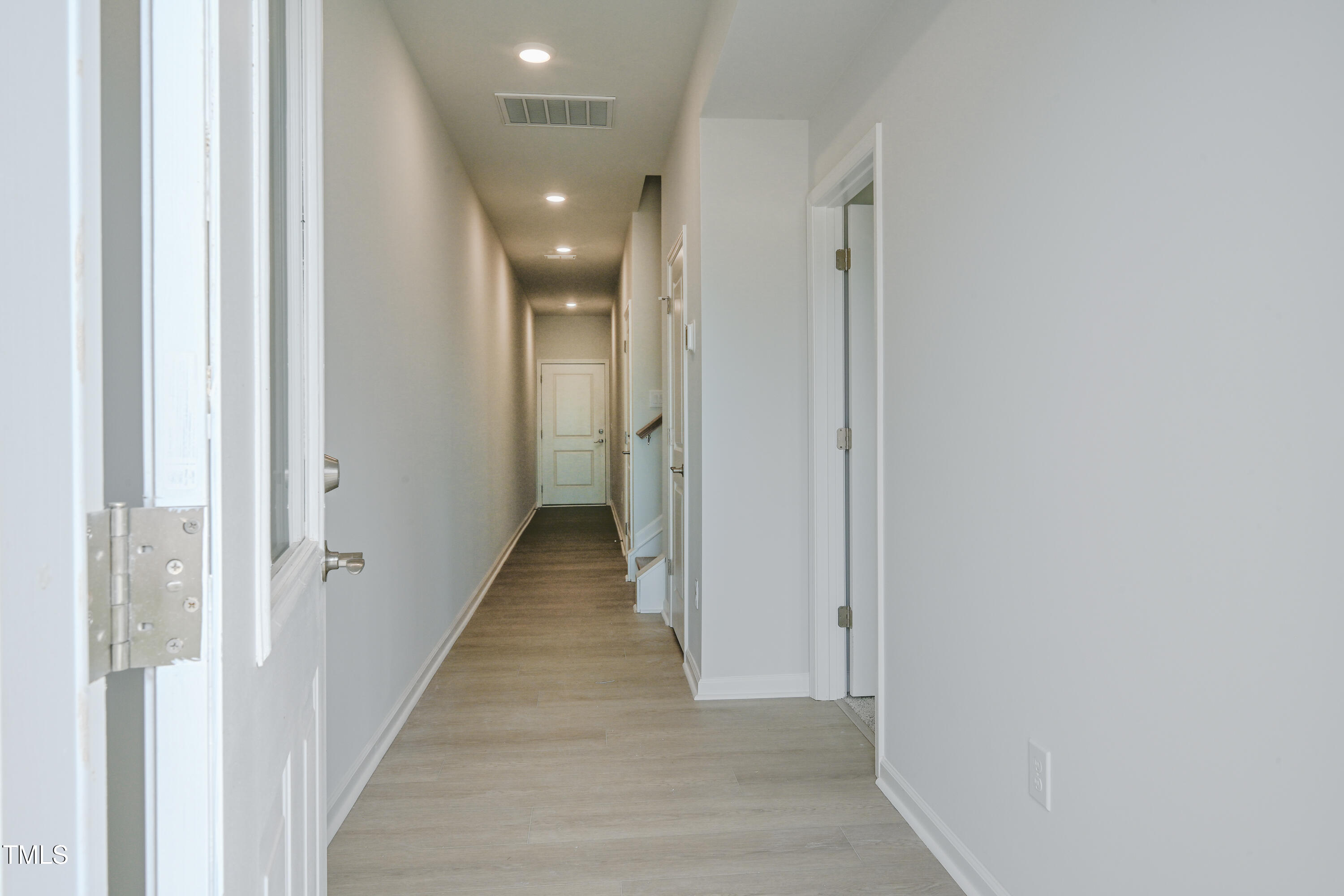 1511 Tamarisk Lane Durham, NC 27703 - Photo 6 of 26 a view of a hallway with wooden floor and staircase