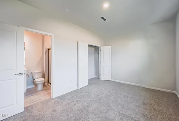 a big room with closet and a toilet