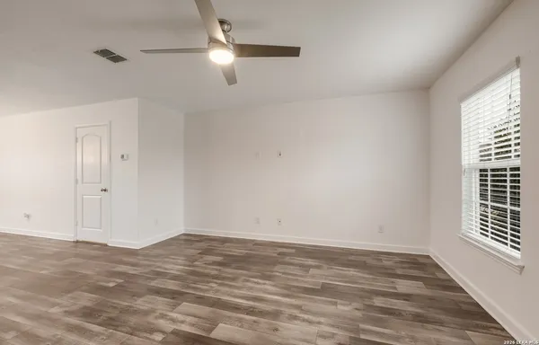 wooden floor in an empty room with a window
